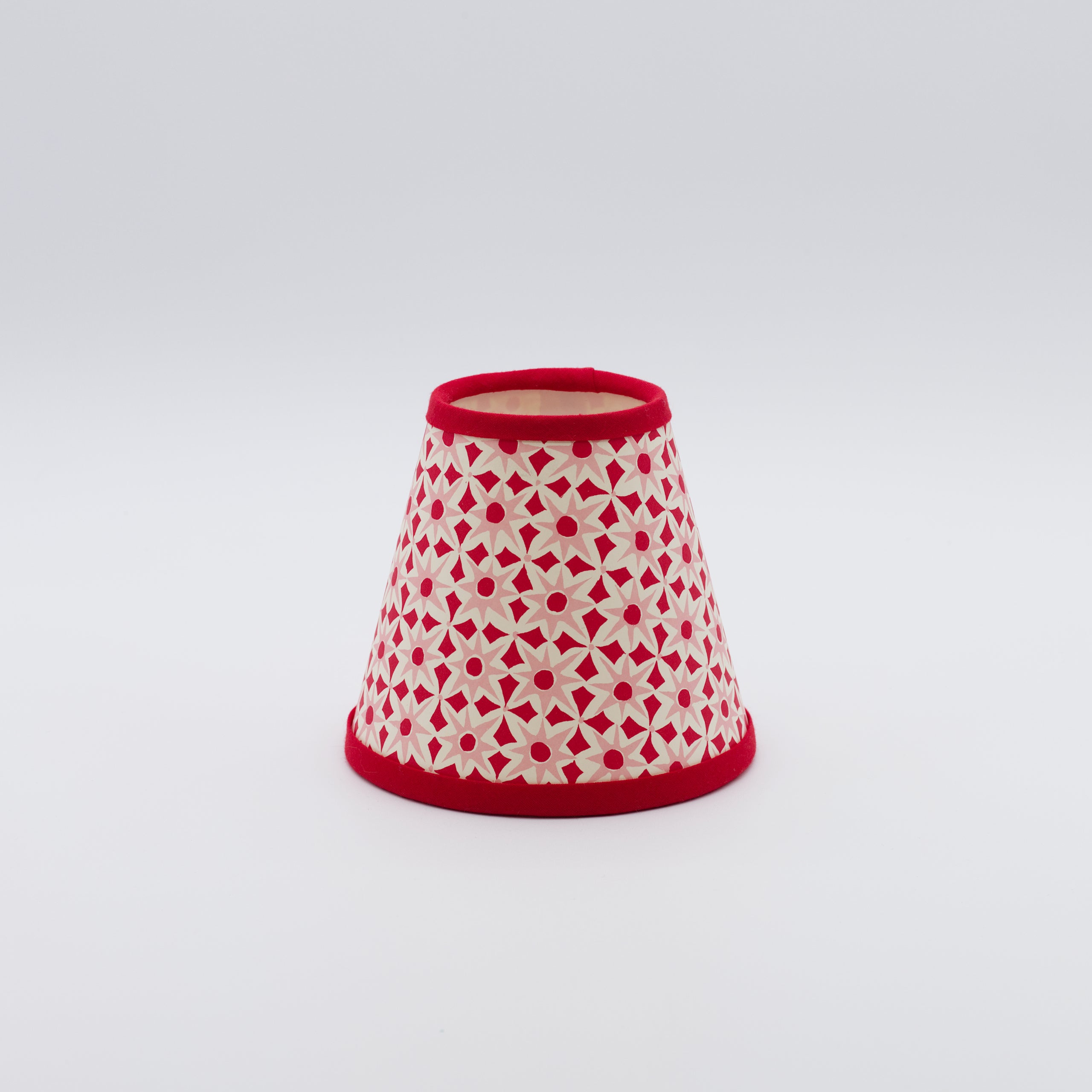 Alhambra lampshade in red and pink — geometric interlocking pattern on a handmade conical paper shade.