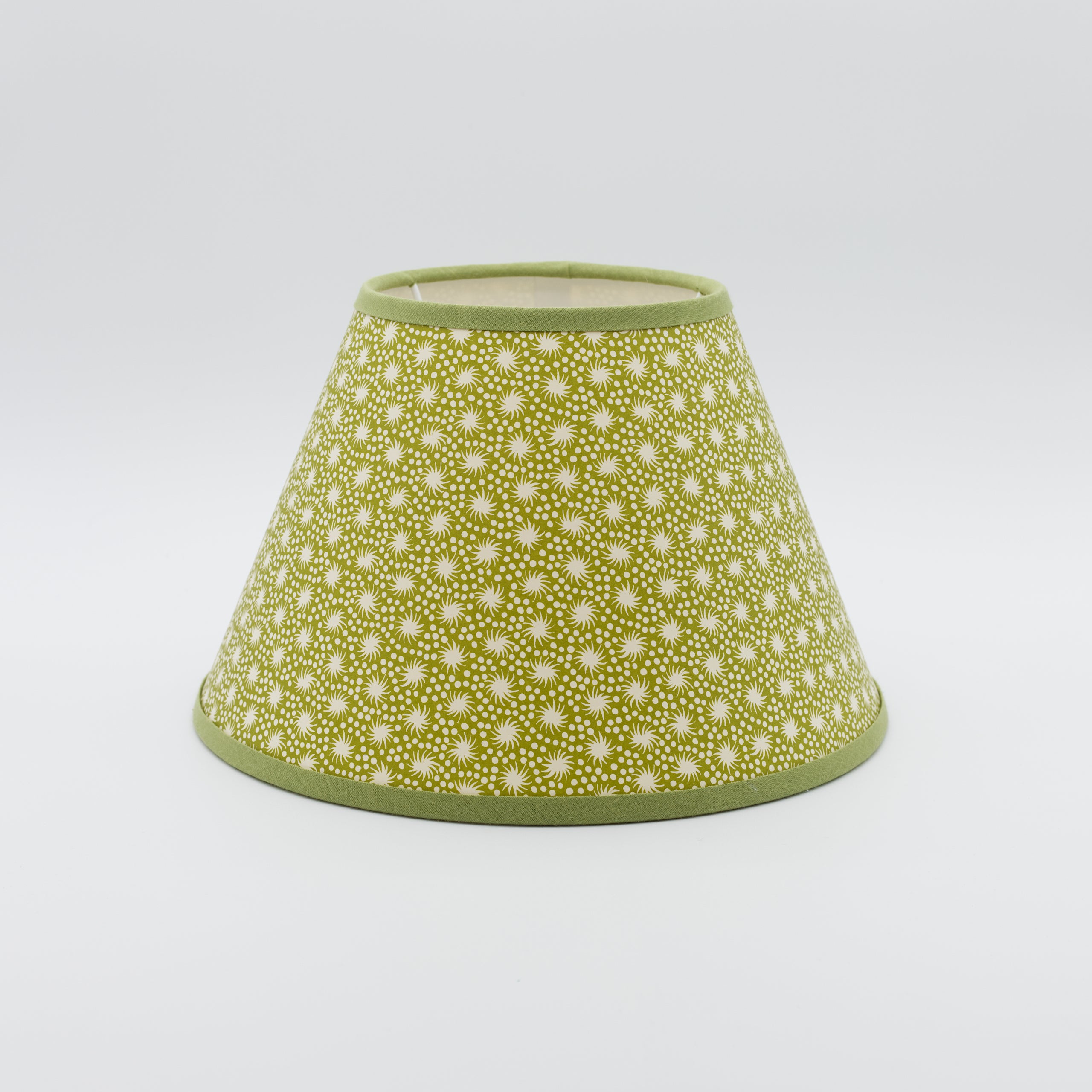 Animalcules lampshade in green — scattered organic speckle pattern on a handmade conical paper shade.