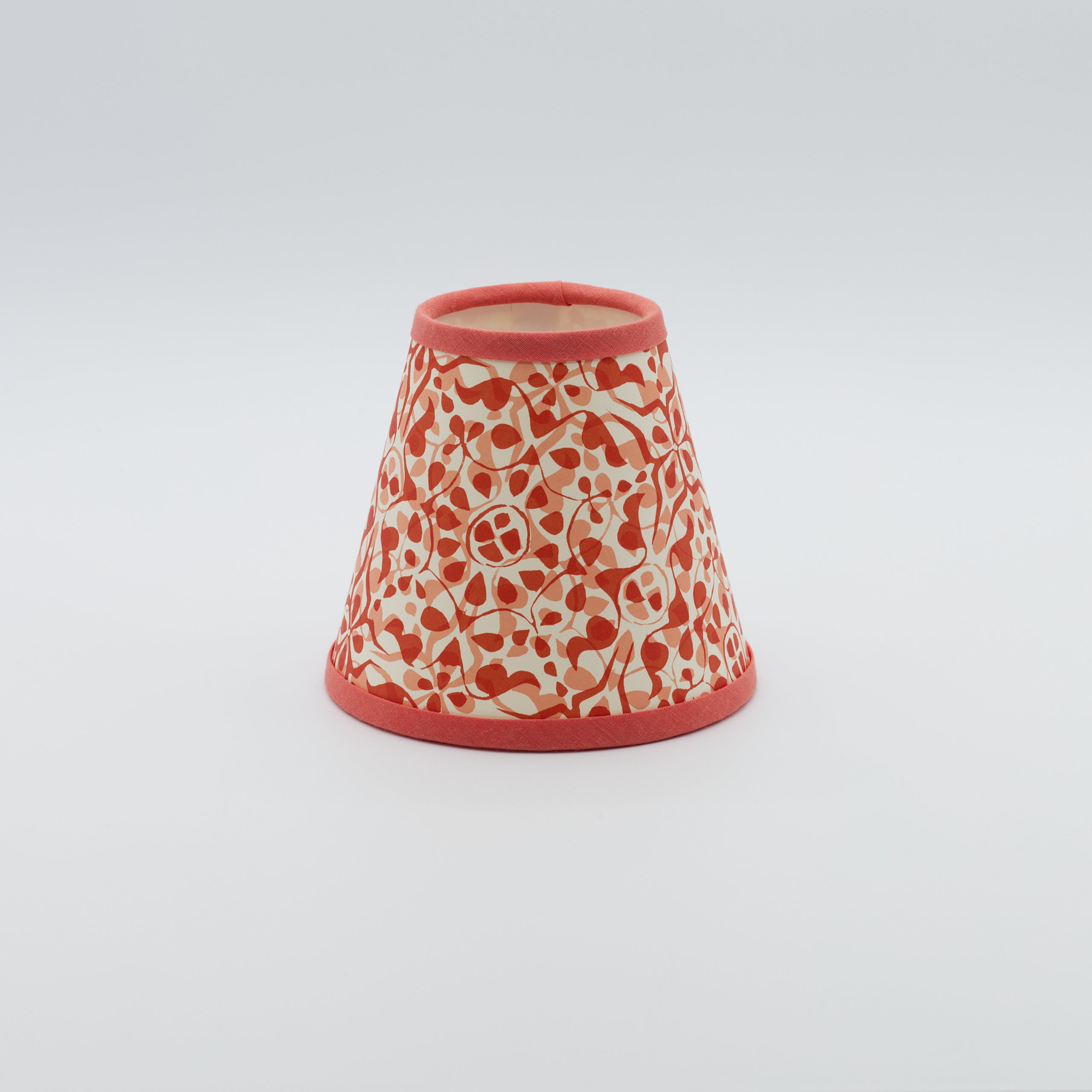Dappled Red lampshade — dappled spot texture in red and orange on a handmade conical paper shade.