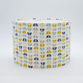 Half Moon Harbour lampshade — blue and multicolour half-moon pattern on a cotton drum shade.