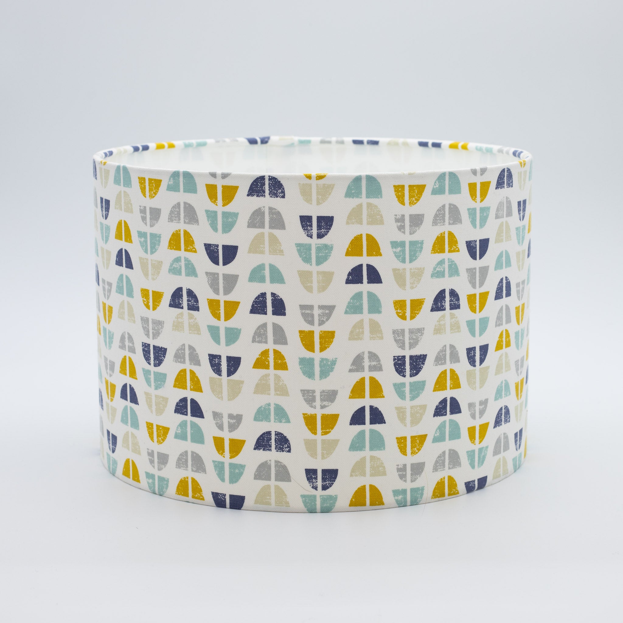 Half Moon Harbour lampshade — blue and multicolour half-moon pattern on a cotton drum shade.
