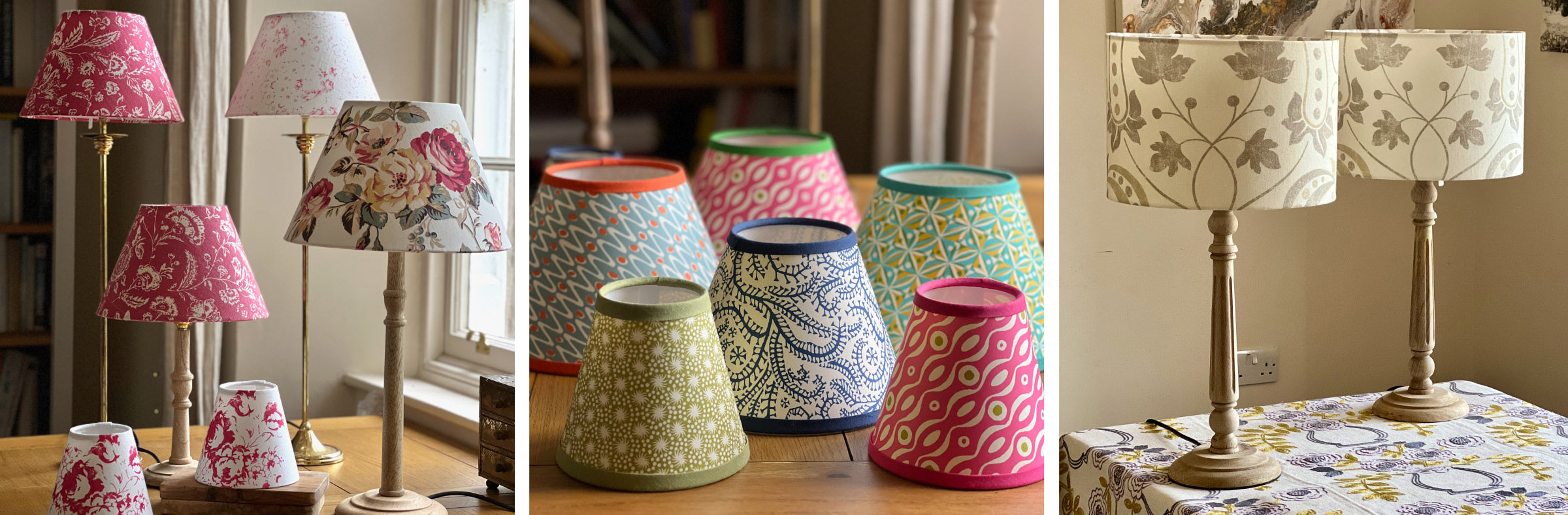 Colourful lampshades and lamps in groups on a wooden table by the window. 