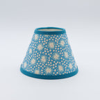 Milky Way lampshade in blue — scattered star-and-dot pattern on a handmade conical paper shade.