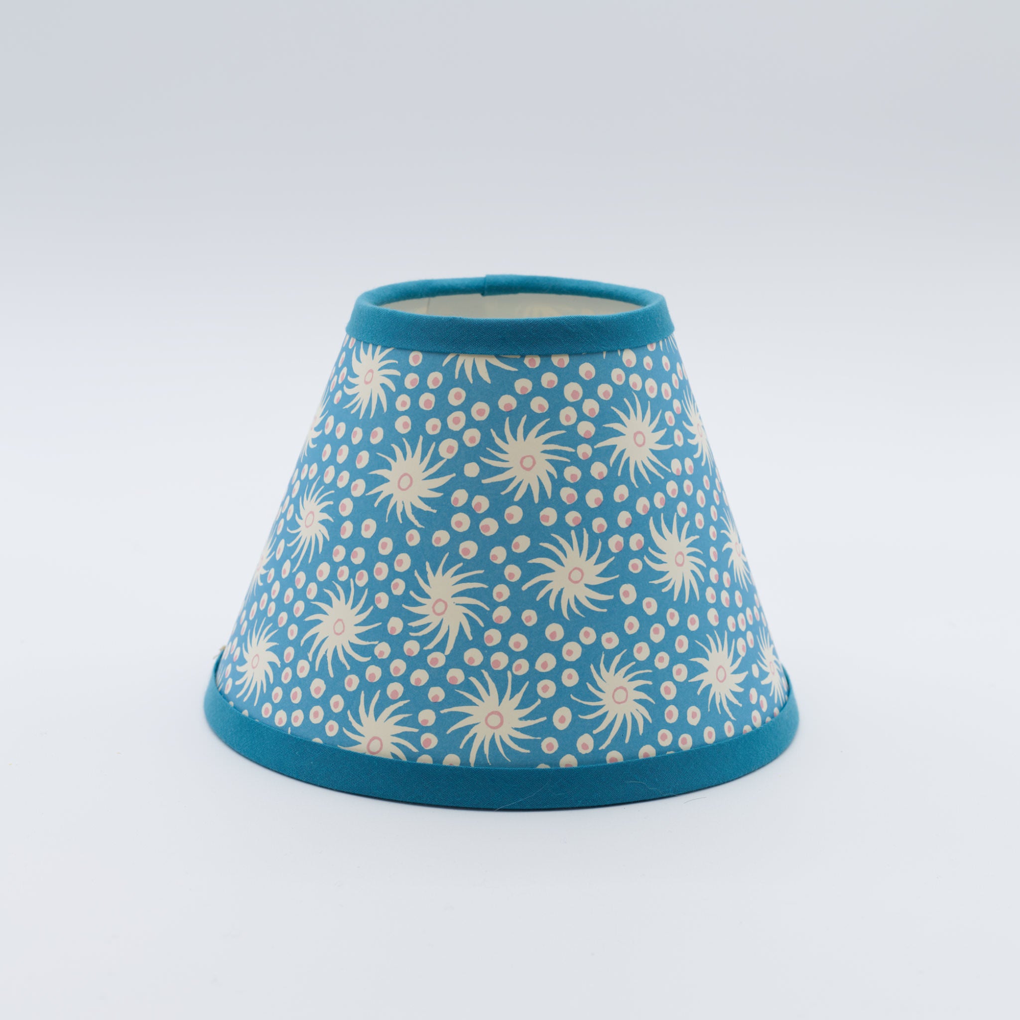 Milky Way lampshade in blue — scattered star-and-dot pattern on a handmade conical paper shade.