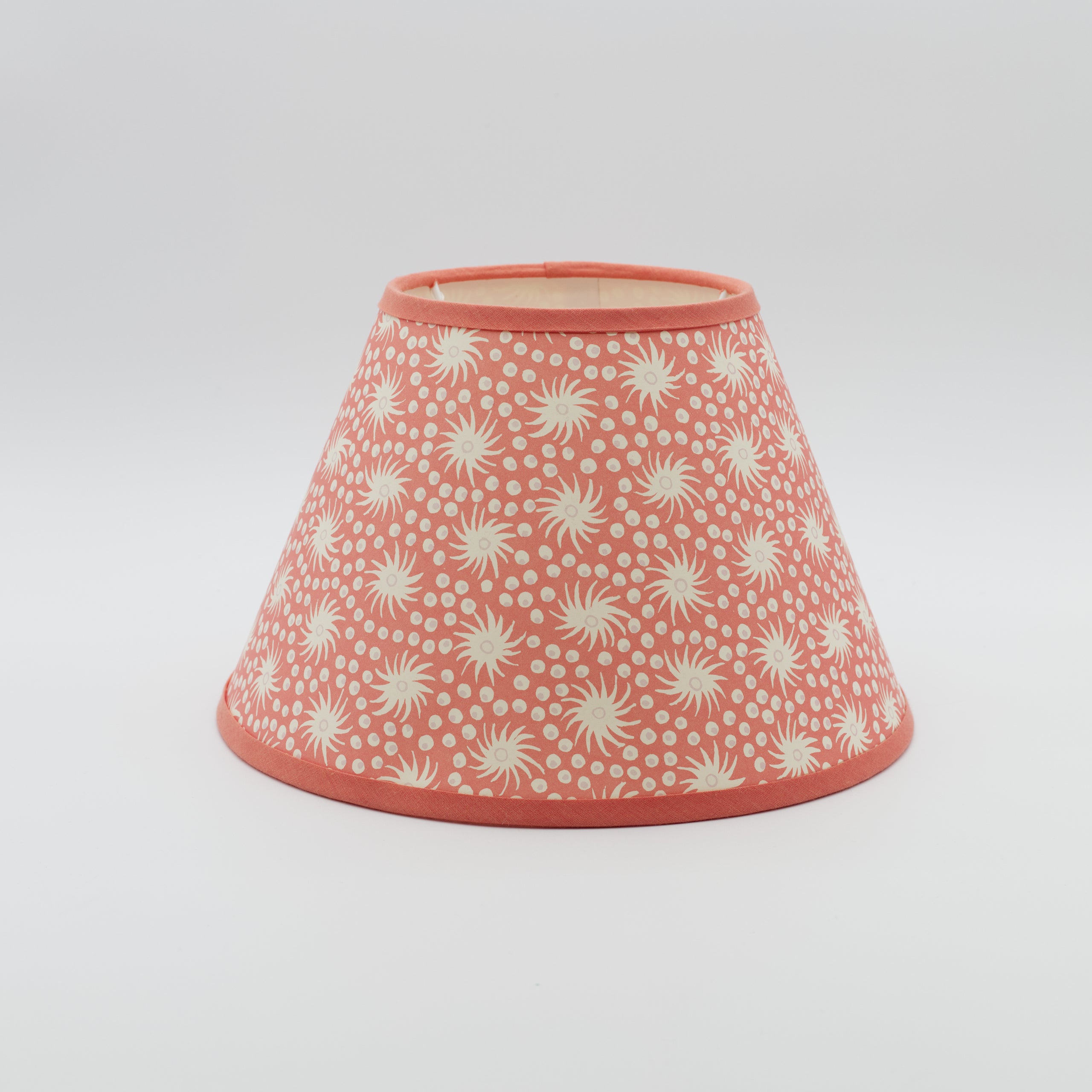 Milky Way lampshade in pink and red — scattered star-and-dot pattern on a conical paper shade.