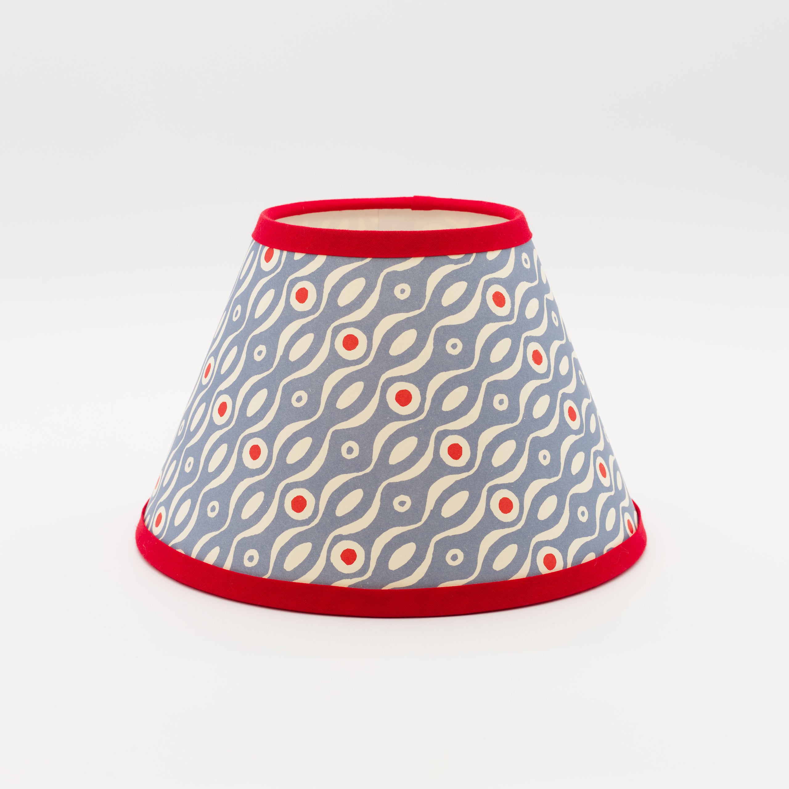 Persephone Cornflower lampshade — cornflower-blue floral sprig pattern on a conical paper shade.