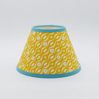 Persephone Mustard lampshade — mustard-yellow floral sprig pattern on a handmade conical paper shade.