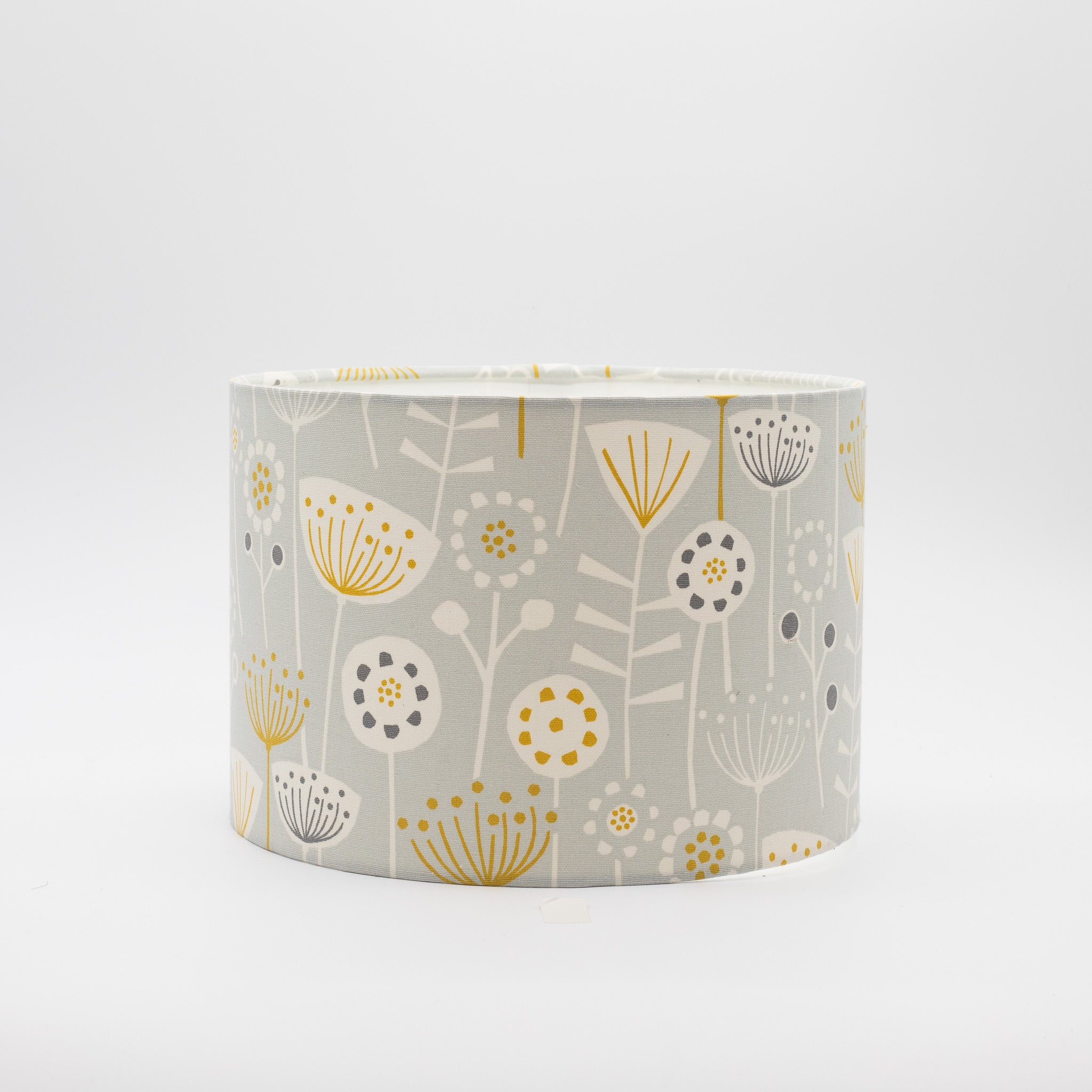 Seedheads lampshade in grey and yellow — botanical seedhead pattern on a cotton drum shade.