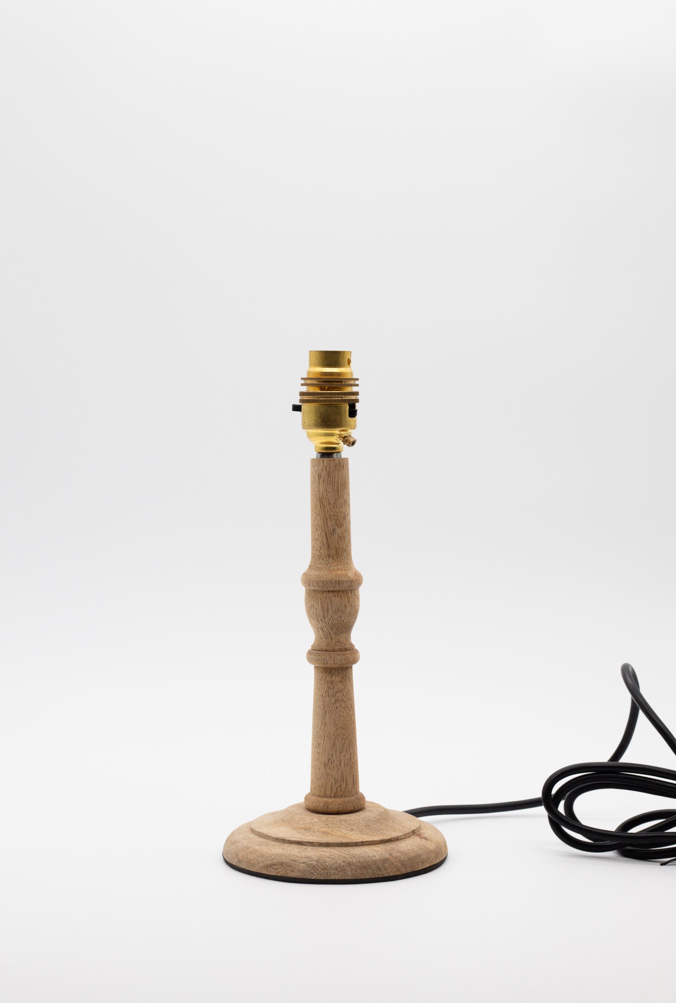 Small turned wooden table lamp base in natural mango wood.