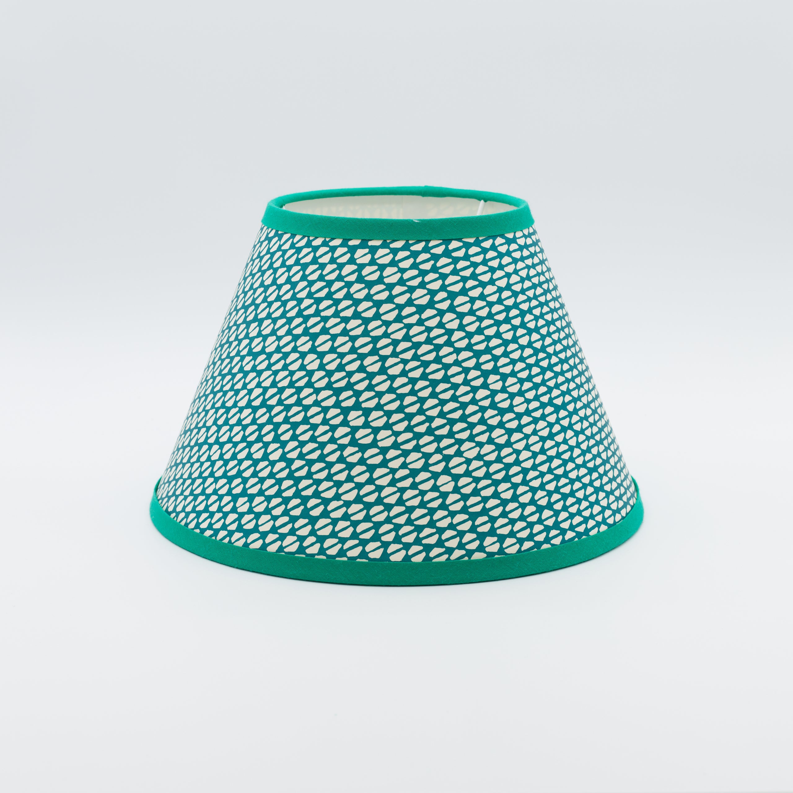 Yo-yo Kingfisher lampshade — teal wavy ogee pattern on a handmade conical paper shade.